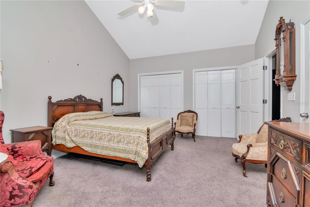 4511 Country Gate Court Valrico, FL 33596 - Photo 40 of 64 a bedroom with bed and a chandelier