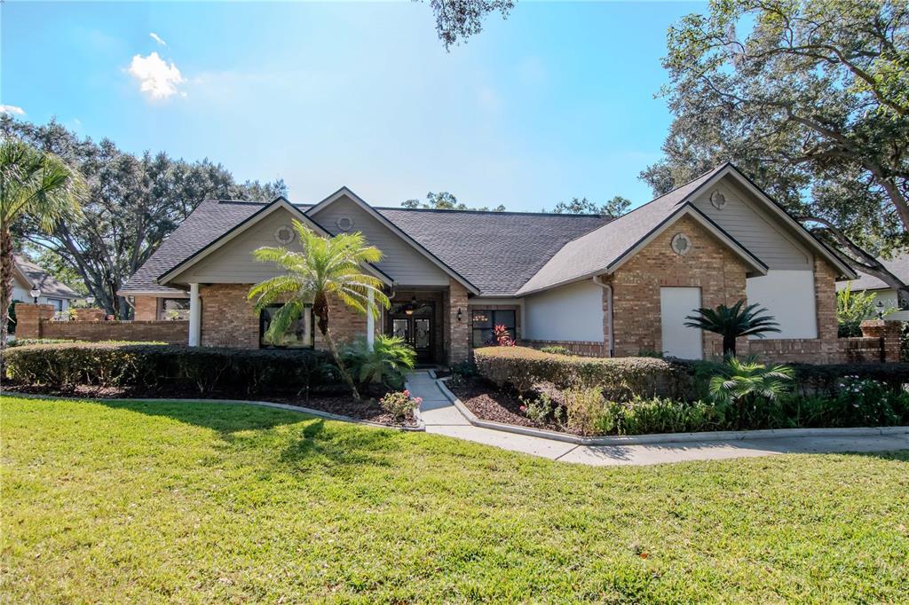 4511 Country Gate Court Valrico, FL 33596 - Photo 63 of 64 a front view of a house with a yard and garage