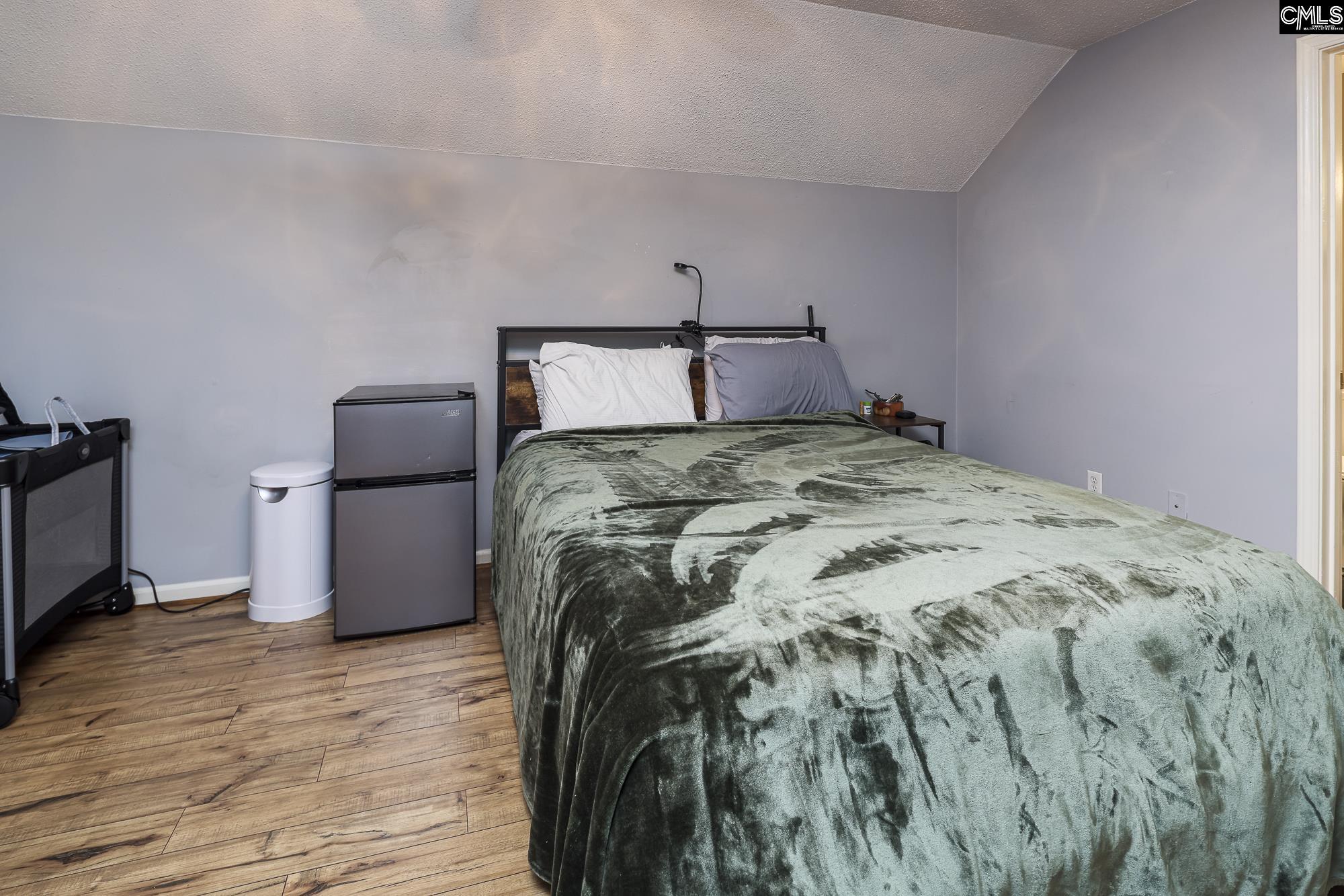 152 Thames Valley Court Irmo, SC 29063 - Photo 23 of 32 a bed sitting in a bedroom next to a window with wooden floor