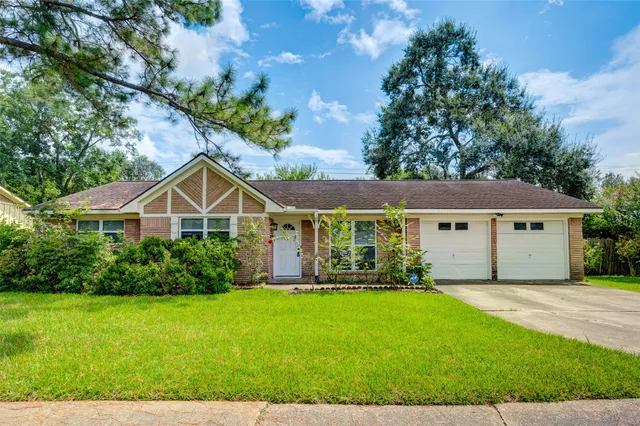 a front view of a house with a yard and porch