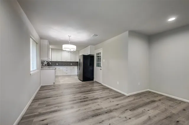 a view of a kitchen with a sink and a refrigerator
