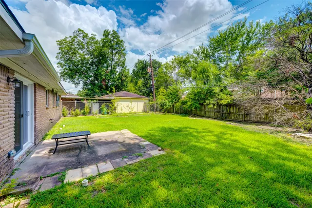 a view of a chair and table on the garden