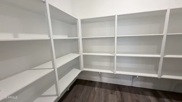 an empty room with windows and bathroom view