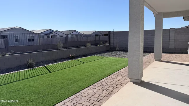 a room with lots of wooden furniture and a large window