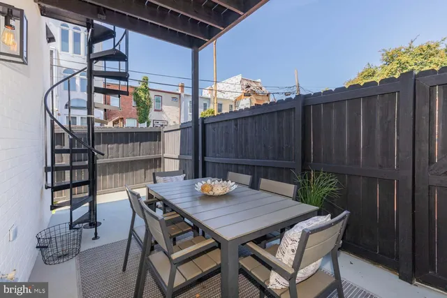 a view of a dinning table and chairs in patio