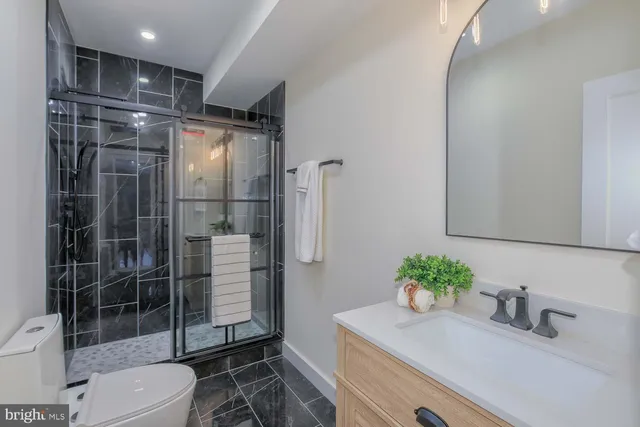 a bathroom with a shower toilet and sink