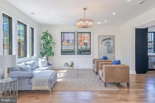 a living room with furniture and a chandelier