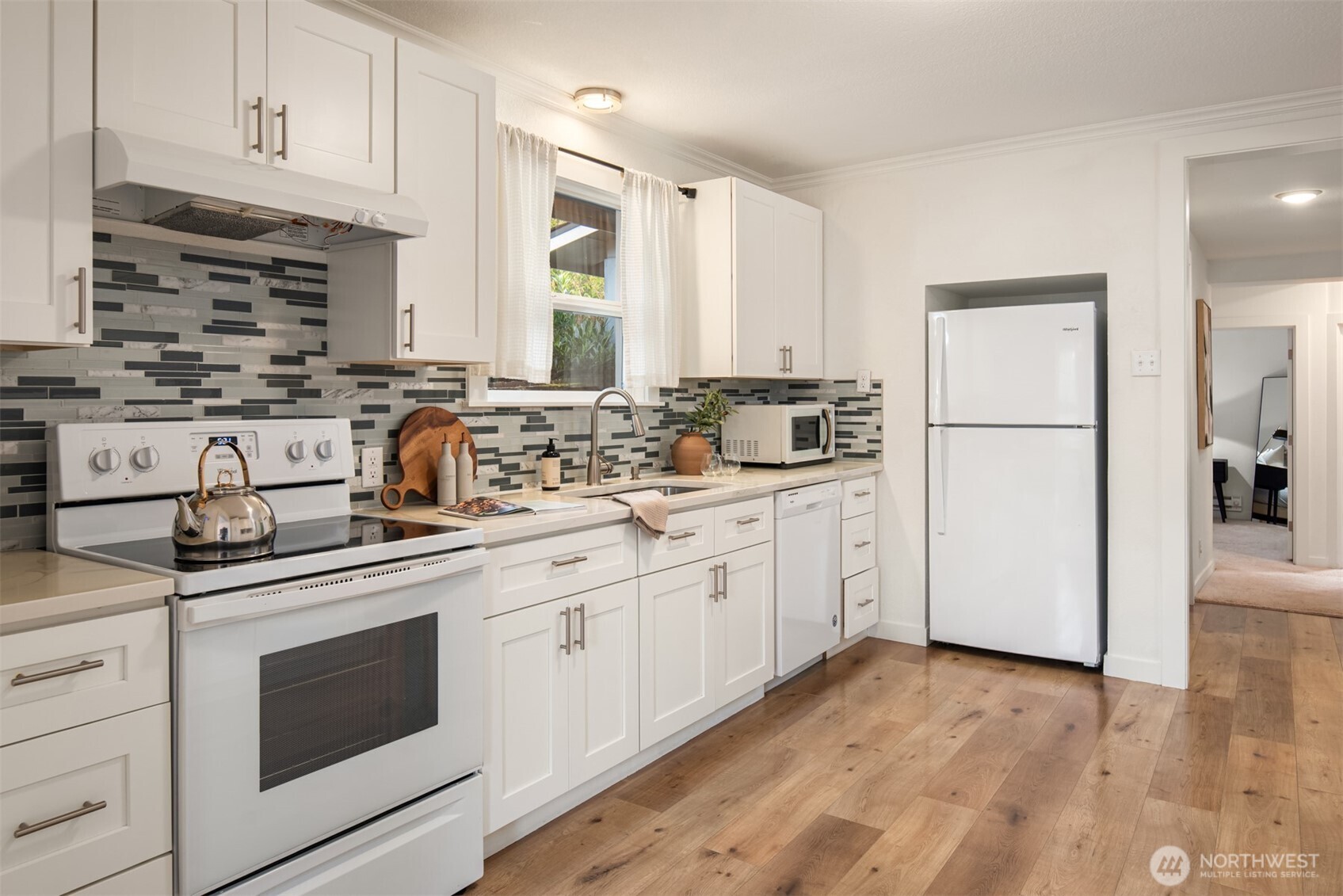 5115 South Roxbury Street Seattle, WA 98118 - Photo 12 of 29 a kitchen with appliances a sink and cabinets