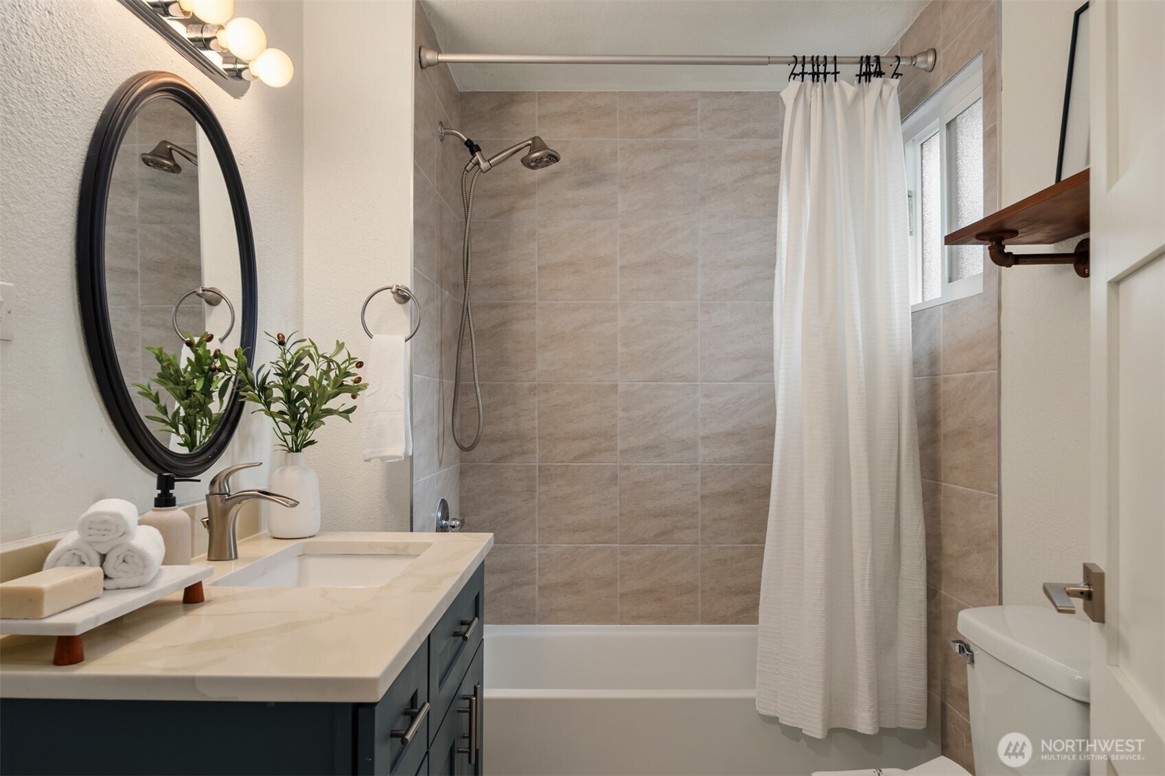 5115 South Roxbury Street Seattle, WA 98118 - Photo 25 of 29 a bathroom with a sink and a mirror