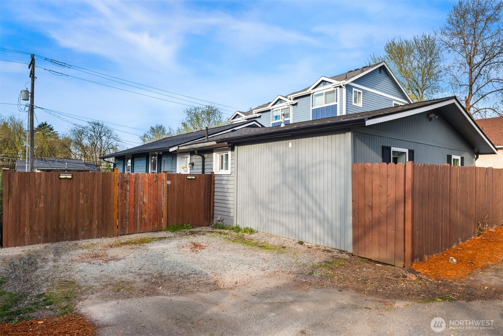 5115 South Roxbury Street Seattle, WA 98118 - Photo 27 of 29 a front view of a house with a wooden fence