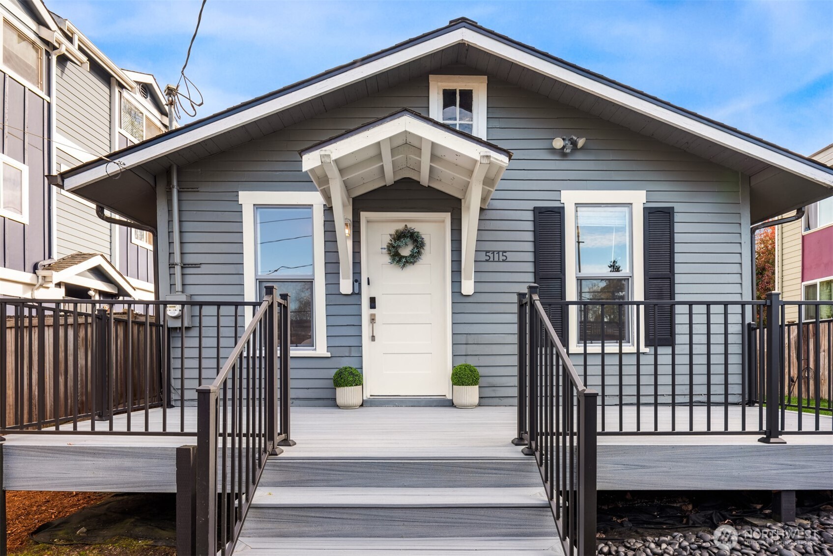 5115 South Roxbury Street Seattle, WA 98118 - Photo 5 of 29 a front view of a house with a balcony