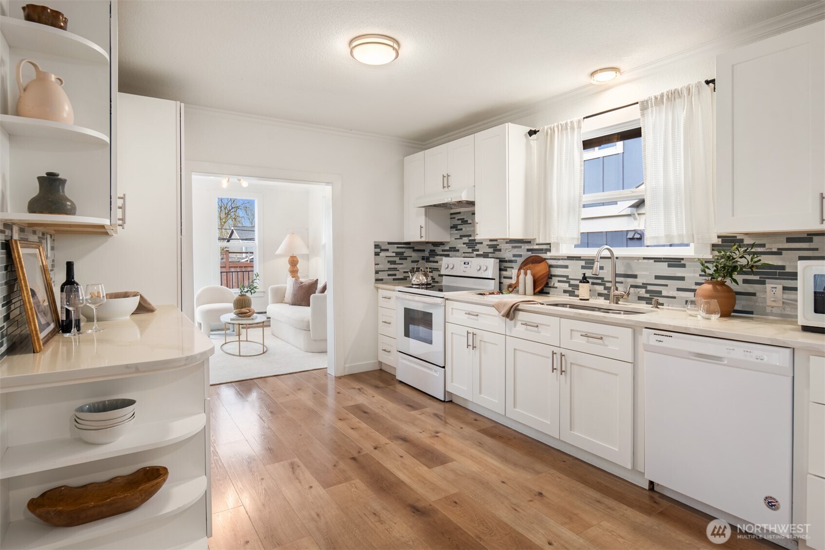 5115 South Roxbury Street Seattle, WA 98118 - Photo 10 of 29 a kitchen with white cabinets stove and sink