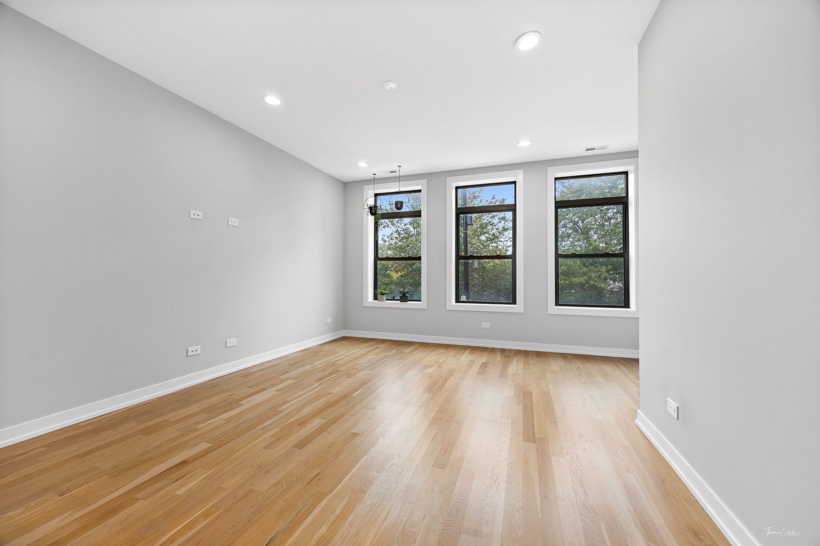 1822 South Throop Street, Unit 2 Chicago, IL 60608 - Photo 4 of 23 wooden floor in an empty room with a window