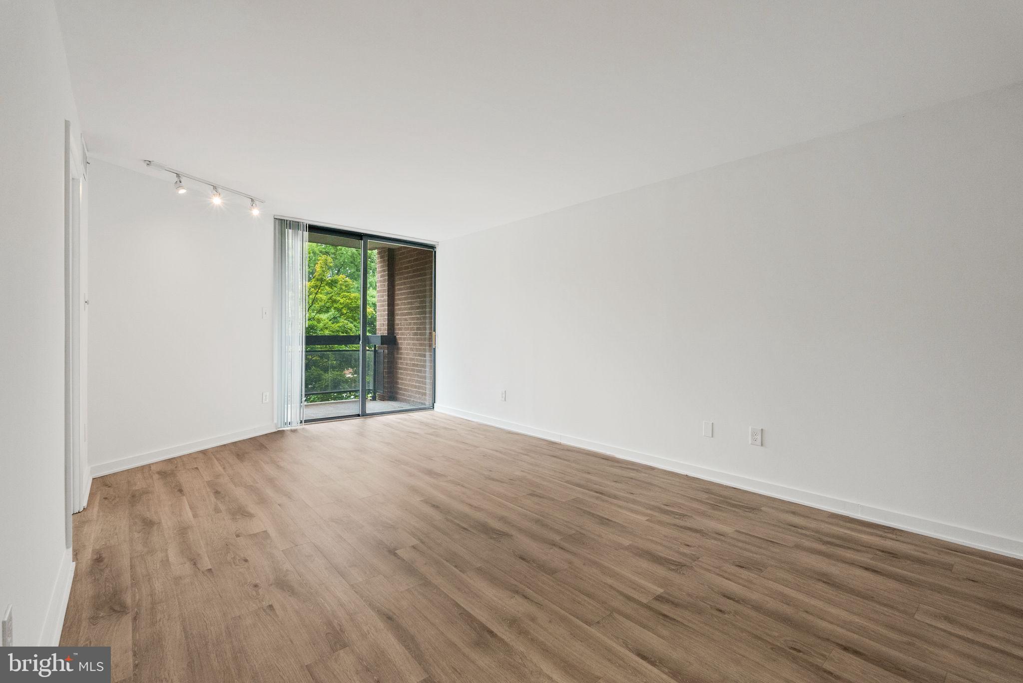 601 24th Street Northwest, Unit 306 Washington, DC 20037 - Photo 14 of 34 a view of an empty room with wooden floor and a window
