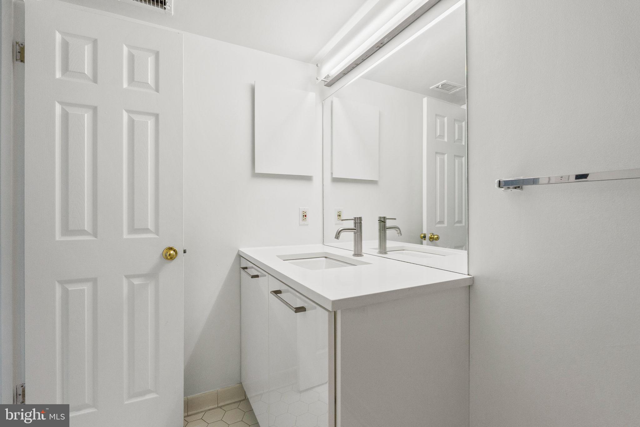 601 24th Street Northwest, Unit 306 Washington, DC 20037 - Photo 17 of 34 a bathroom with a sink and a mirror