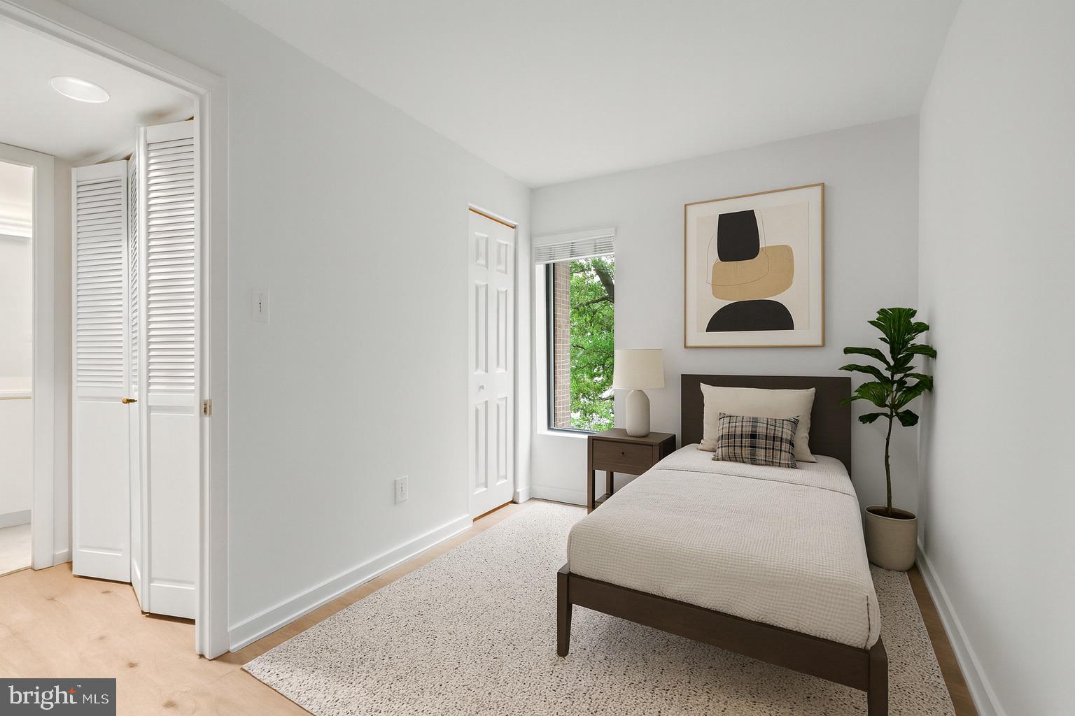 601 24th Street Northwest, Unit 306 Washington, DC 20037 - Photo 19 of 34 a bedroom with a bed and a potted plant