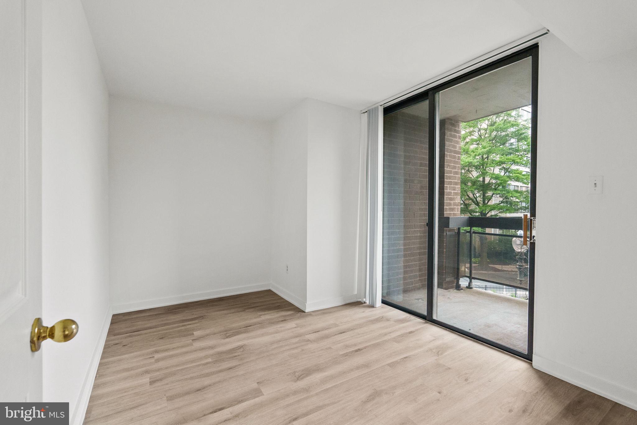 601 24th Street Northwest, Unit 306 Washington, DC 20037 - Photo 23 of 34 a view of an empty room with wooden floor and a window