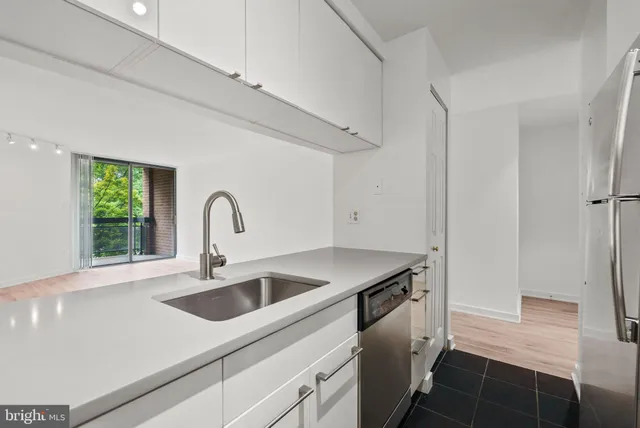a kitchen with a sink and a refrigerator