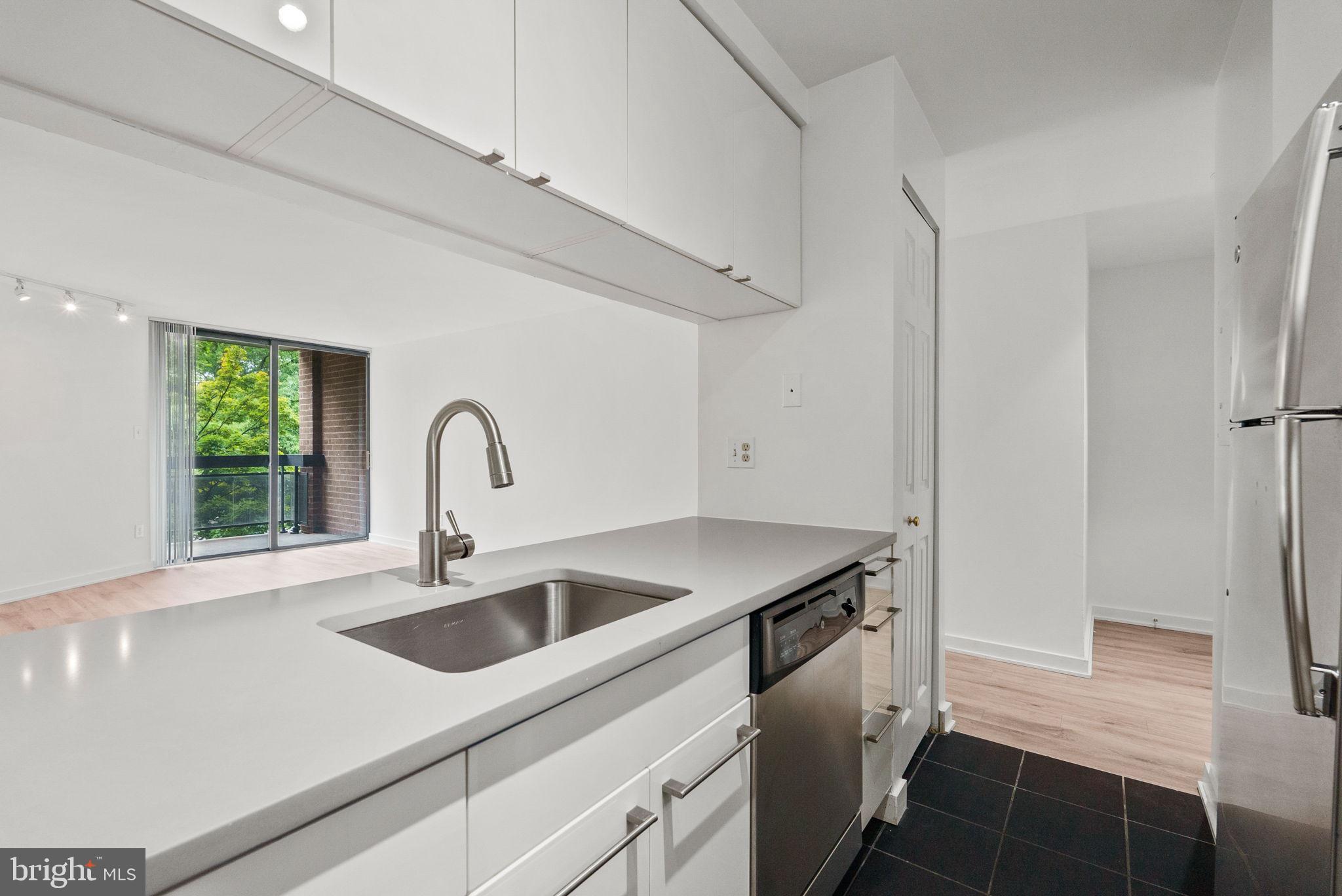 601 24th Street Northwest, Unit 306 Washington, DC 20037 - Photo 9 of 34 a kitchen with a sink and a refrigerator