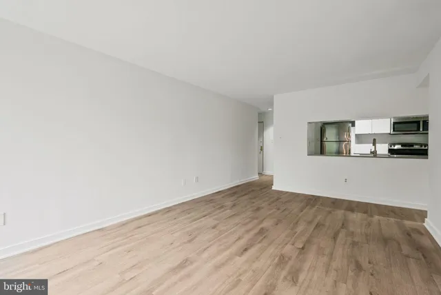 a view of a kitchen with wooden floor and a sink