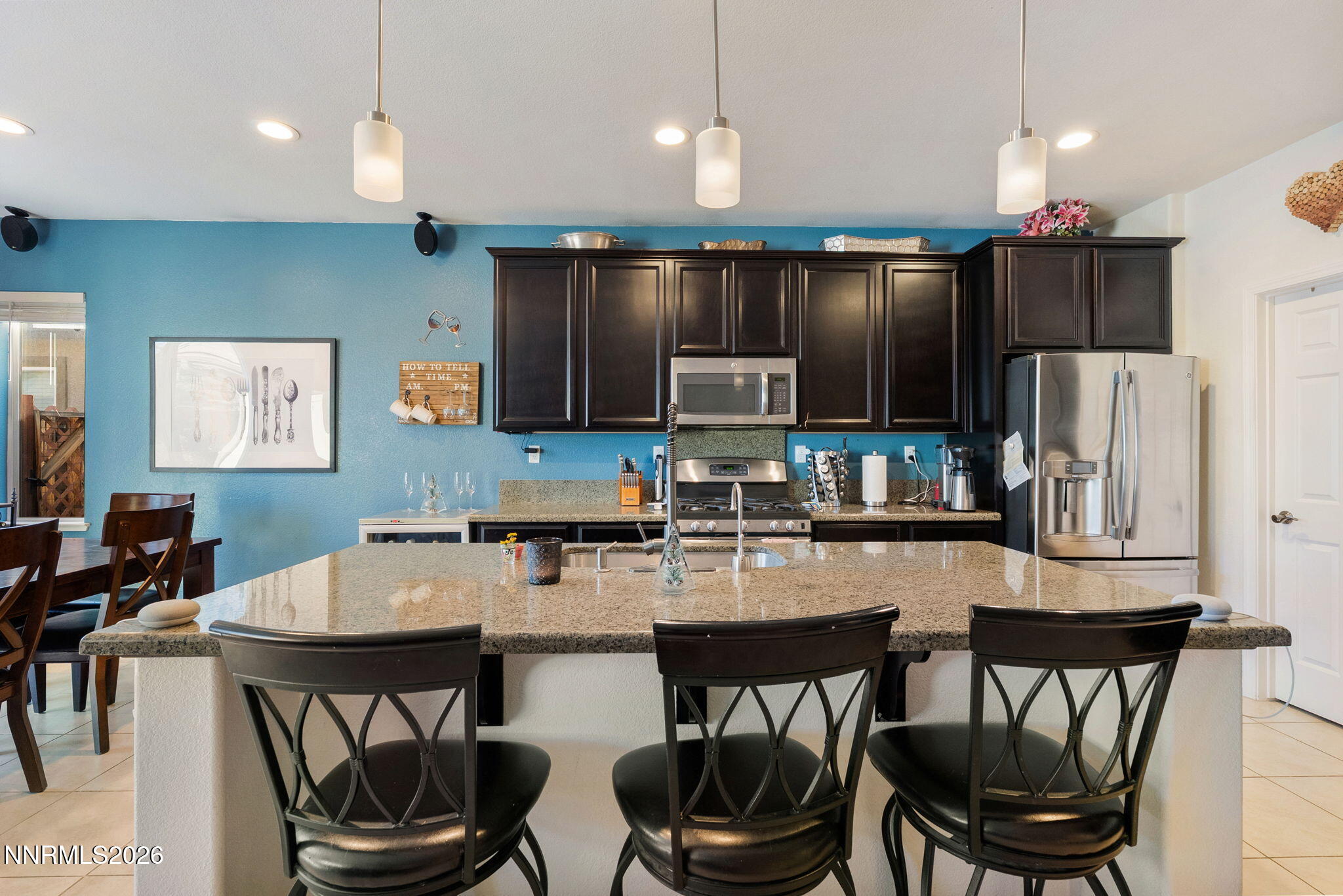 2190 Dutch Draft Drive Reno, NV 89521 - Photo 14 of 32 a kitchen with a dining table chairs appliances and cabinets