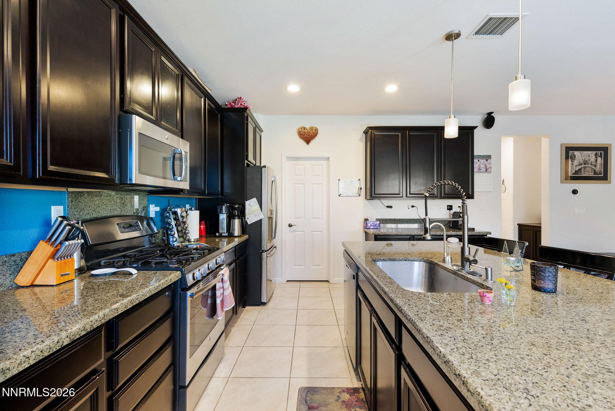 2190 Dutch Draft Drive Reno, NV 89521 - Photo 16 of 32 a kitchen with stainless steel appliances granite countertop a sink a stove and a refrigerator