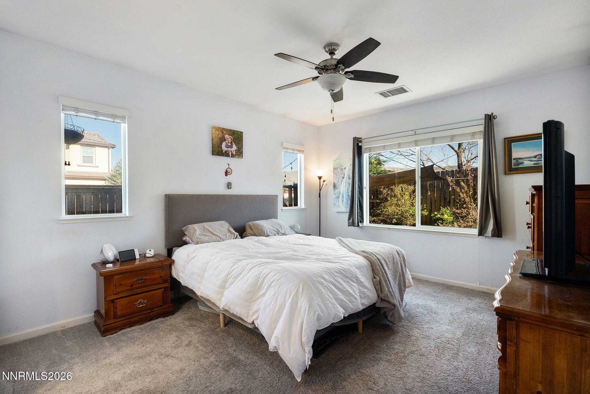 2190 Dutch Draft Drive Reno, NV 89521 - Photo 19 of 32 a bedroom with a bed and a flat tv screen on dresser