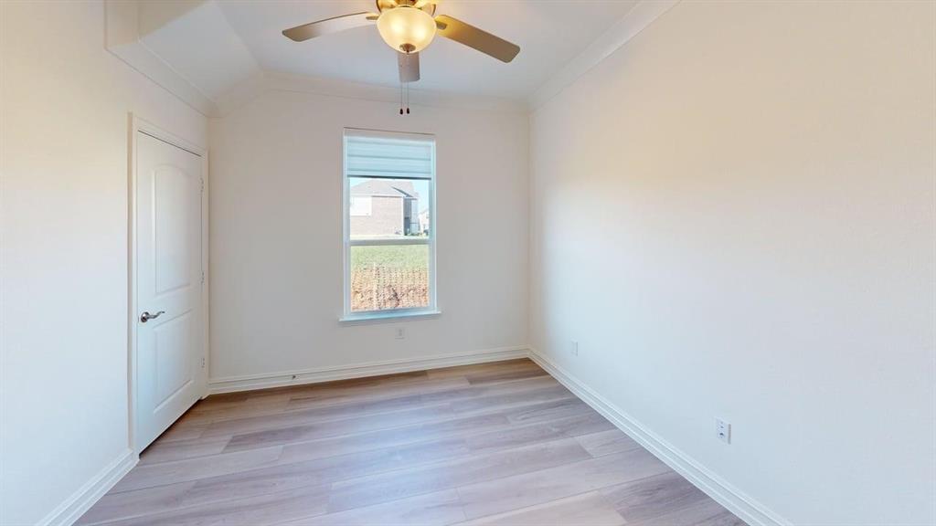 1616 Prosper Lane Anna, TX 75409 - Photo 13 of 24 Empty room with light wood finished floors, ceiling fan, and ornamental molding