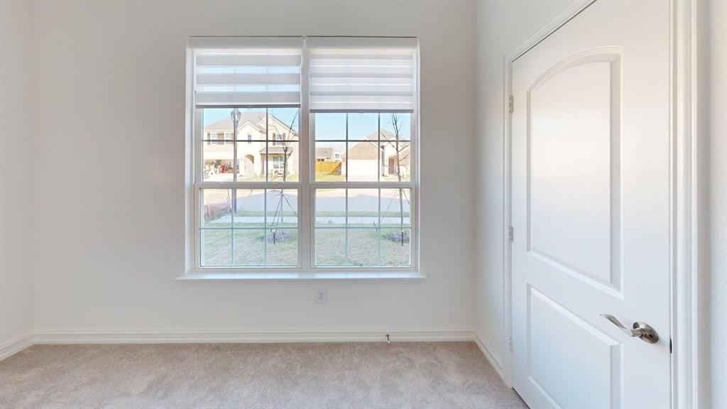 1616 Prosper Lane Anna, TX 75409 - Photo 17 of 24 Unfurnished room with baseboards and light carpet