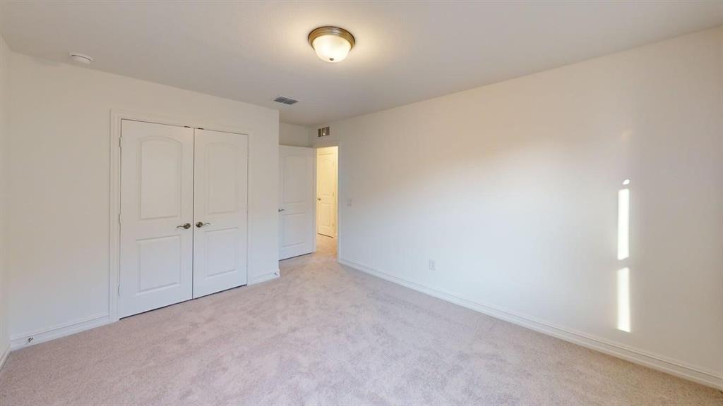 1616 Prosper Lane Anna, TX 75409 - Photo 18 of 24 Unfurnished bedroom featuring light carpet and a closet