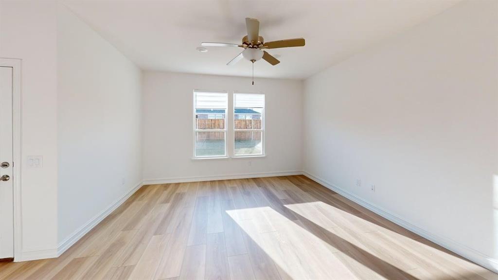 1616 Prosper Lane Anna, TX 75409 - Photo 5 of 24 Empty room featuring light wood-style floors and a ceiling fan