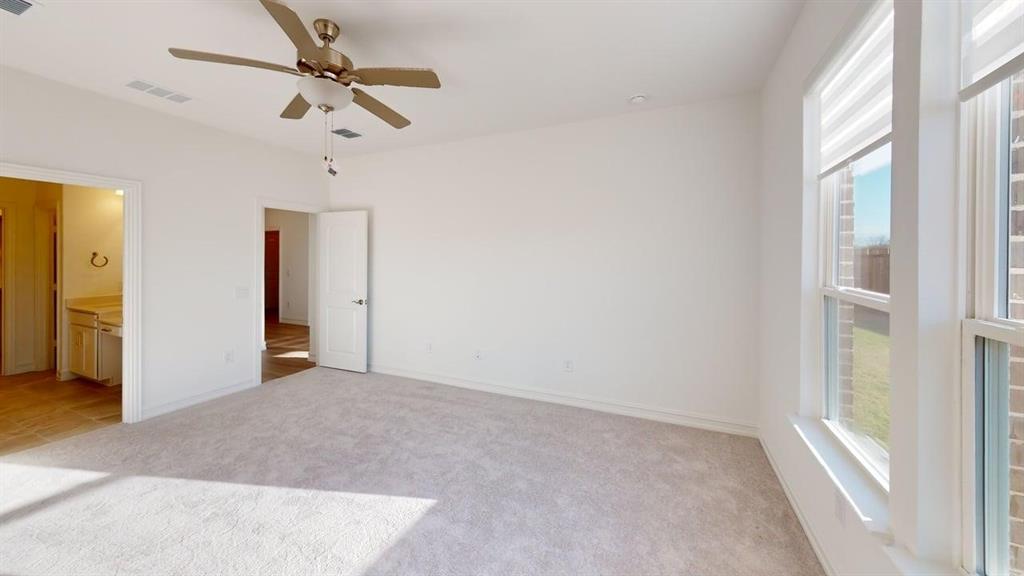 1616 Prosper Lane Anna, TX 75409 - Photo 9 of 24 Unfurnished bedroom with light carpet, a ceiling fan, and ensuite bath