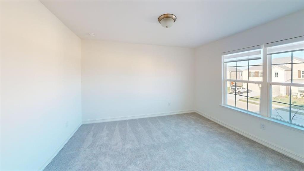 1616 Prosper Lane Anna, TX 75409 - Photo 10 of 24 Empty room featuring light colored carpet and baseboards