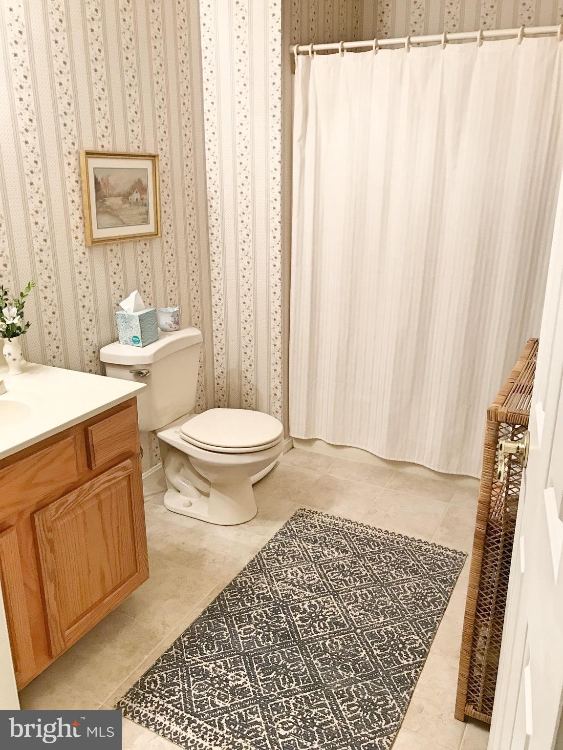885 Carson Road Huntingtown, MD 20639 - Photo 22 of 30 a bathroom with a sink a toilet a window and shower