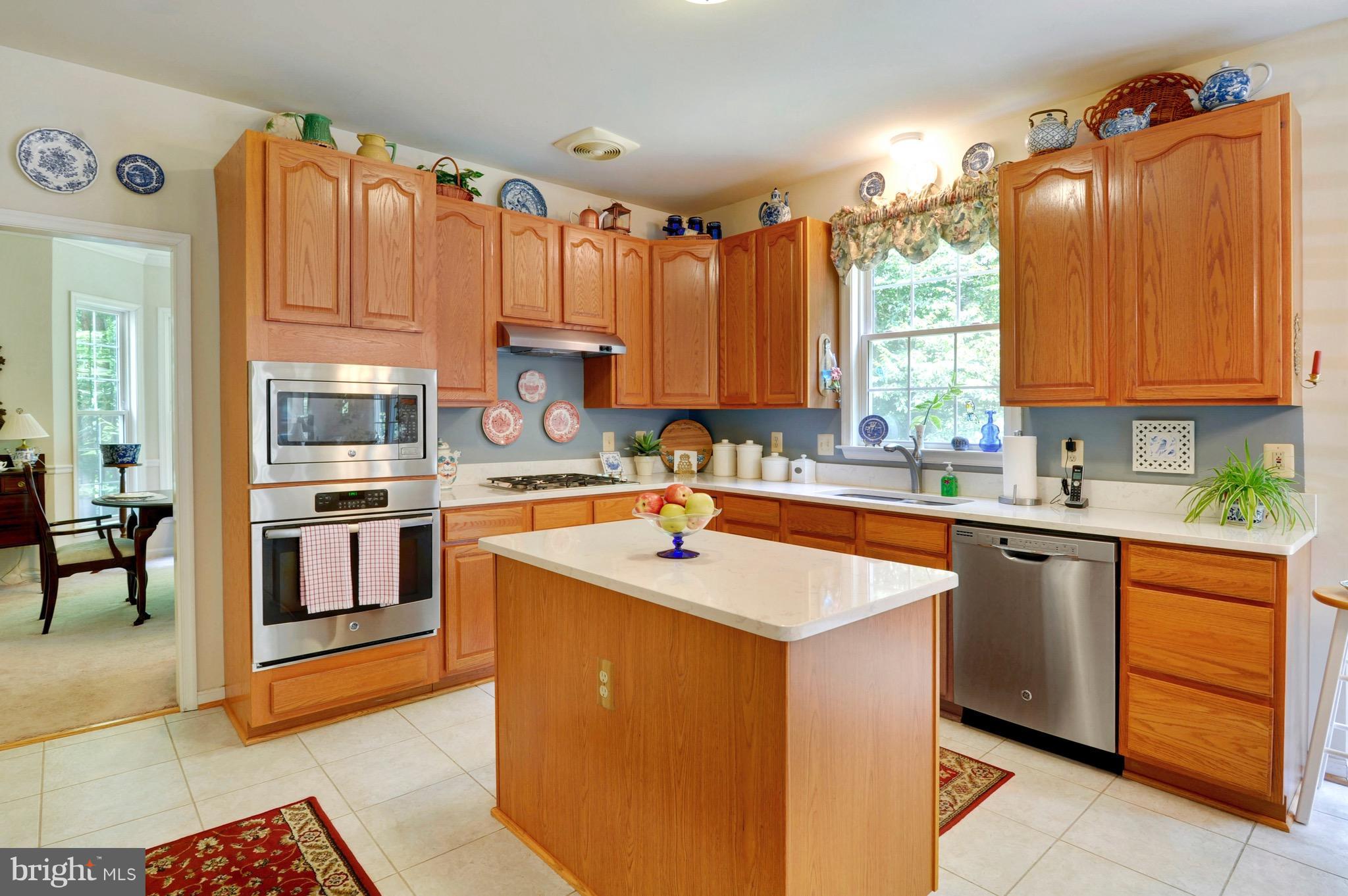 885 Carson Road Huntingtown, MD 20639 - Photo 8 of 30 a kitchen with stainless steel appliances granite countertop a stove a sink dishwasher and a refrigerator