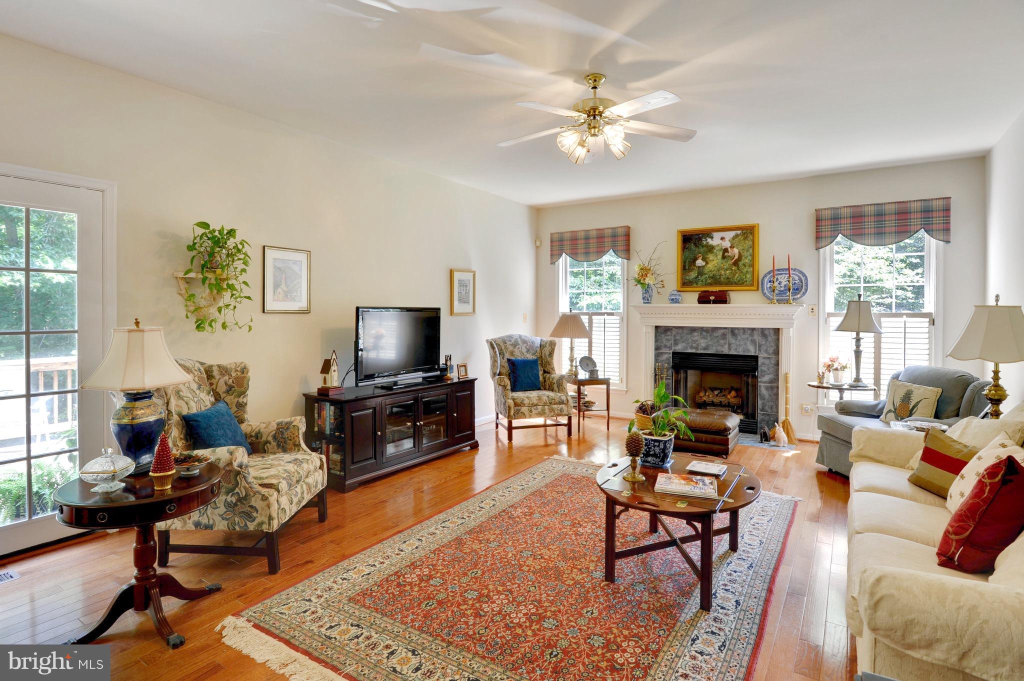 885 Carson Road Huntingtown, MD 20639 - Photo 10 of 30 a living room with furniture a fireplace and a flat screen tv