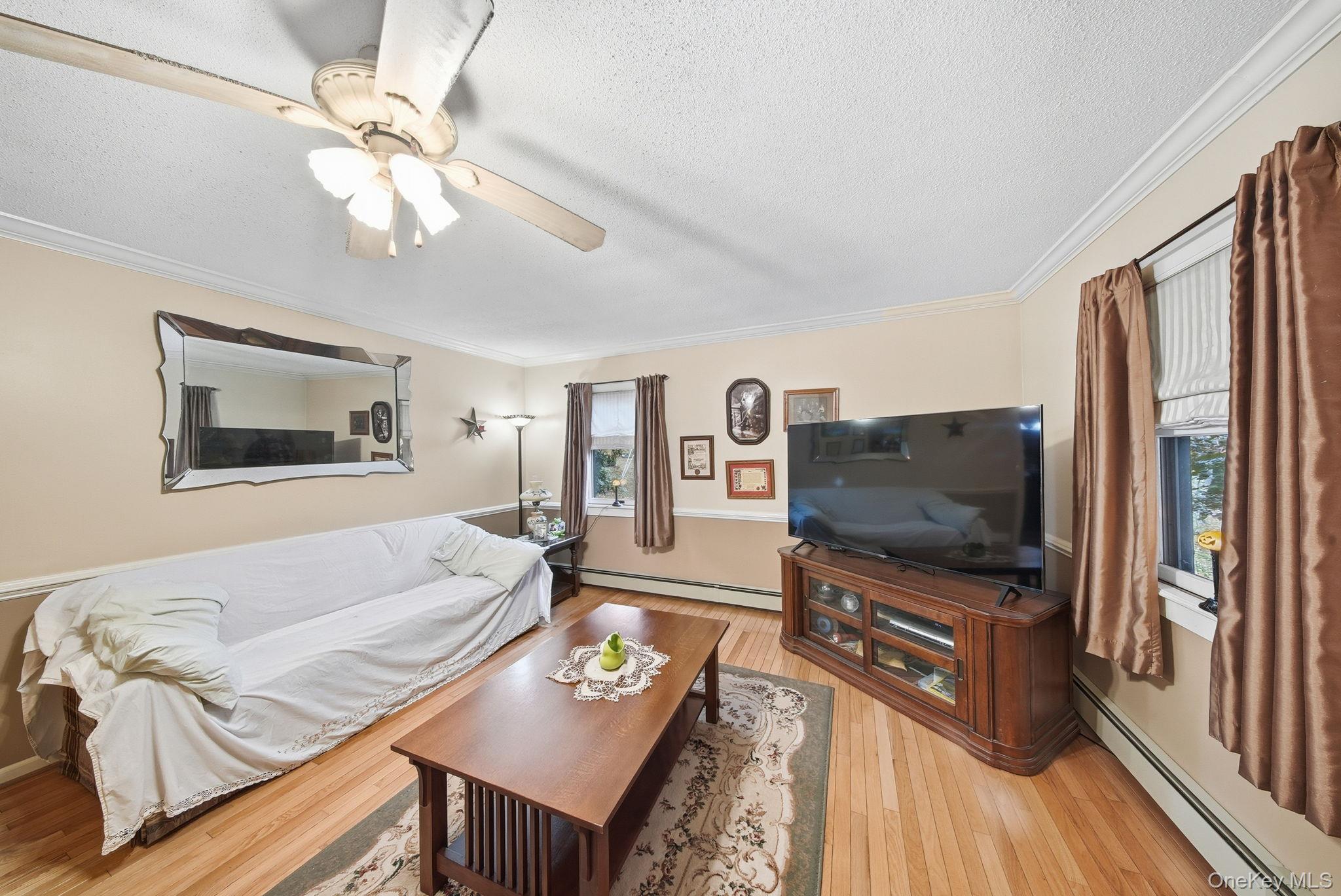 45 Coopers Corners Road Monticello, NY 12701 - Photo 12 of 38 a living room with furniture and a flat screen tv