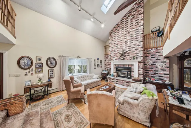 a living room with furniture a fireplace and a flat tv screen