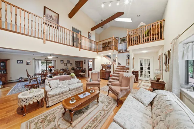 a living room with furniture and a ceiling fan