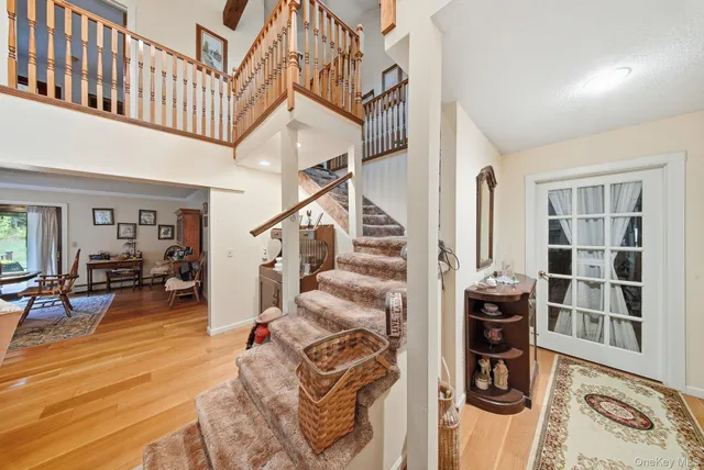 a view of entryway and hall with wooden floor