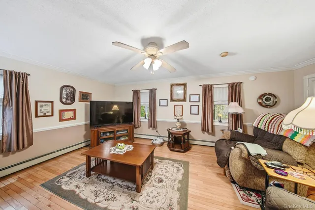 a living room with furniture a rug and a flat screen tv