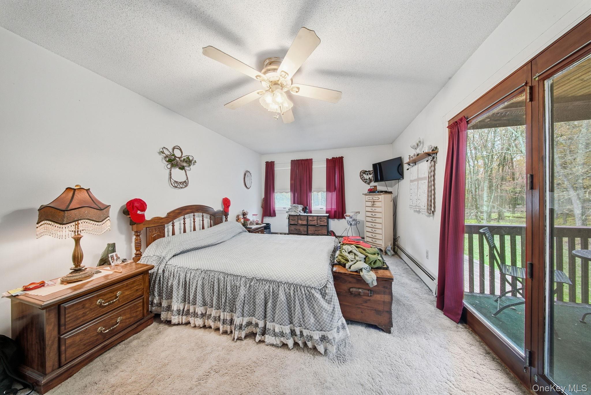 45 Coopers Corners Road Monticello, NY 12701 - Photo 22 of 38 a bedroom with a bed and a chandelier