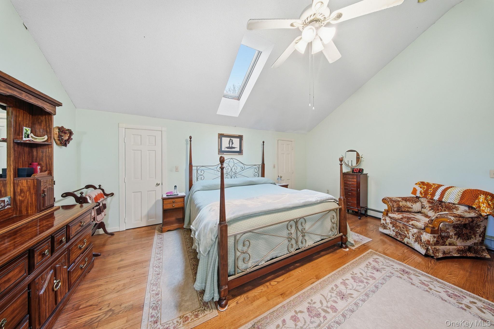 45 Coopers Corners Road Monticello, NY 12701 - Photo 26 of 38 a bed room with a bed and a chandelier