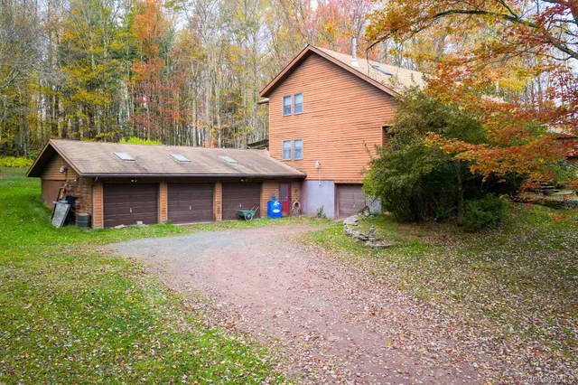 a view of a house with a yard and sitting area
