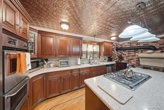 a kitchen with a stove a sink dishwasher and a refrigerator