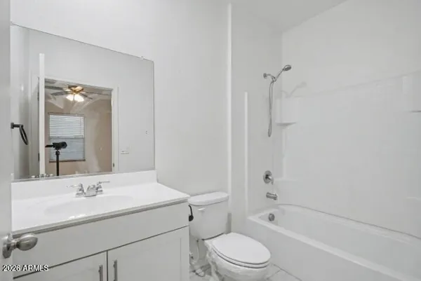 a bathroom with a sink toilet vanity and shower
