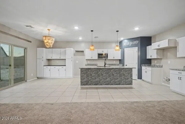 a large kitchen with cabinets and stainless steel appliances