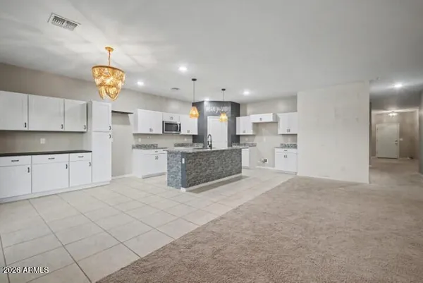 a large white kitchen with cabinets
