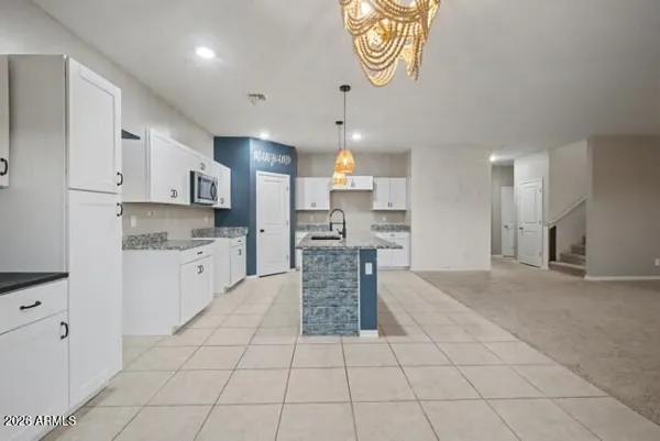 a kitchen with stainless steel appliances a sink and cabinets