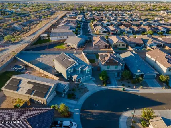 an aerial view of a house with a yard basket ball court and outdoor seating